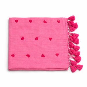 Bright pink Mul cotton saree featuring small red heart prints and matching pink tassels.